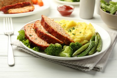 Photo of Delicious baked turkey meatloaf with mashed potato served on white wooden table, closeup