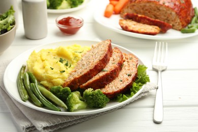 Photo of Delicious baked turkey meatloaf with mashed potato served on white wooden table, closeup