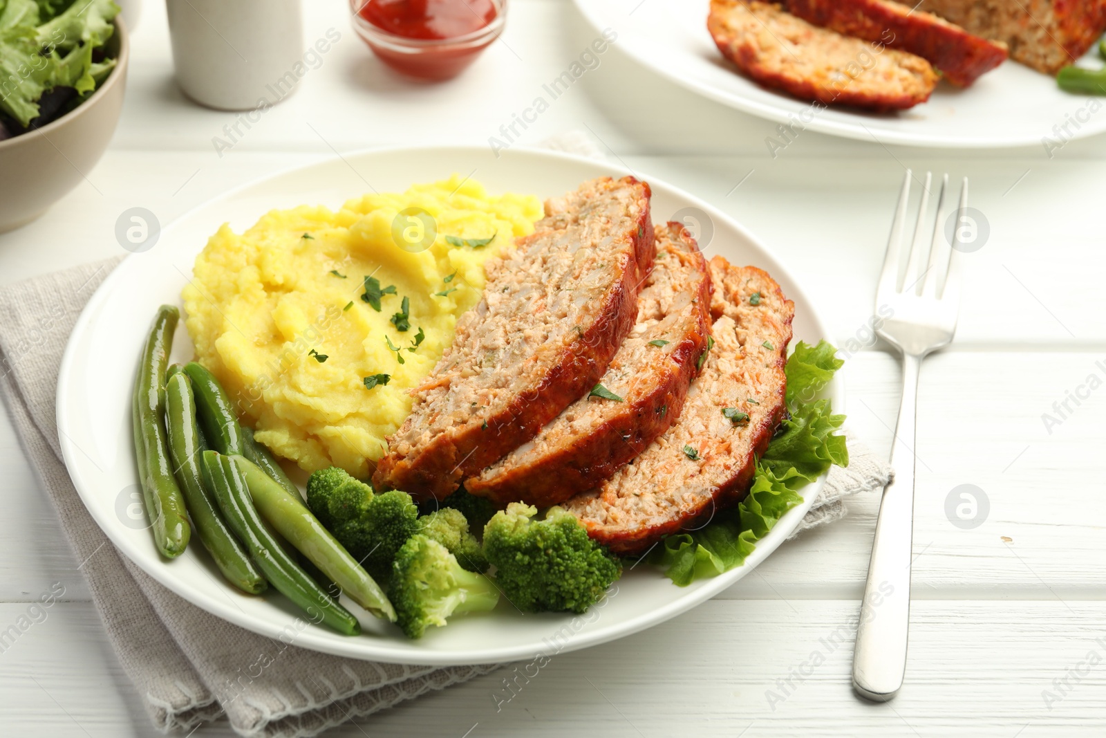 Photo of Delicious baked turkey meatloaf with mashed potato served on white wooden table, closeup