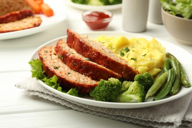 Photo of Delicious baked turkey meatloaf with mashed potato served on white wooden table, closeup