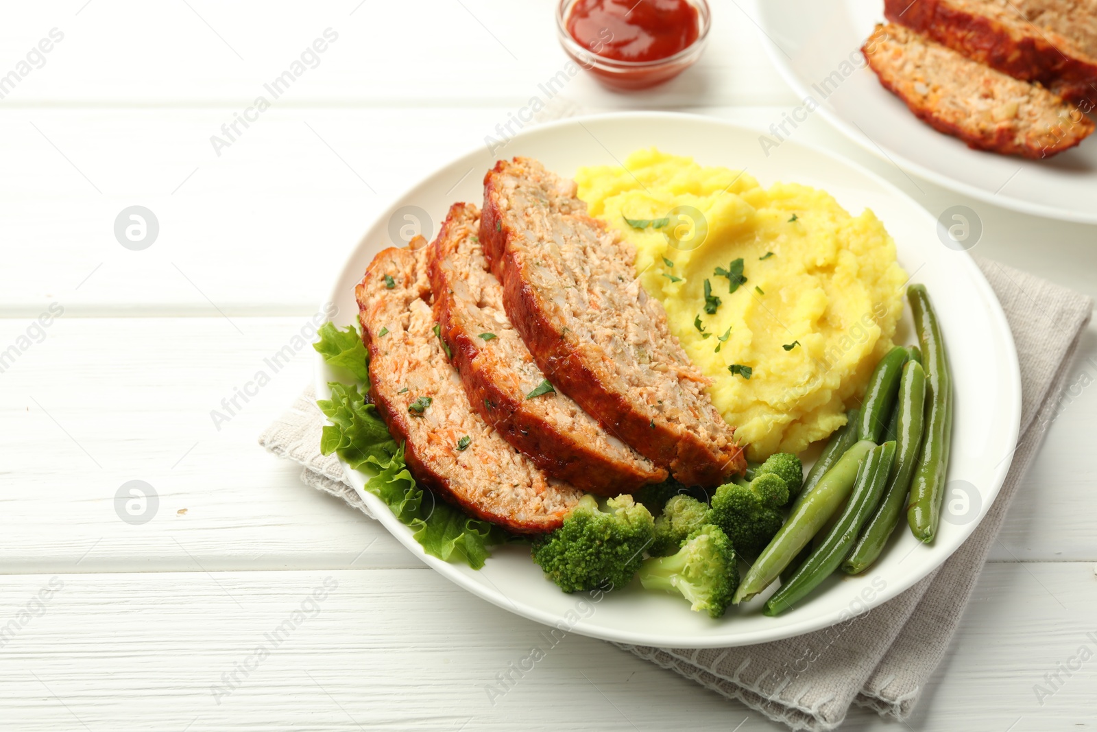 Photo of Delicious baked turkey meatloaf with mashed potato served on white wooden table, closeup. Space for text