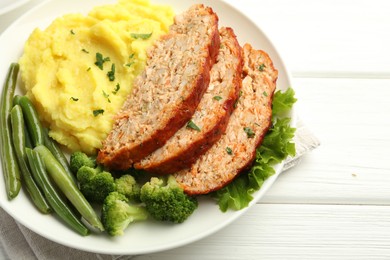 Photo of Delicious baked turkey meatloaf with mashed potato served on white wooden table, above view. Space for text