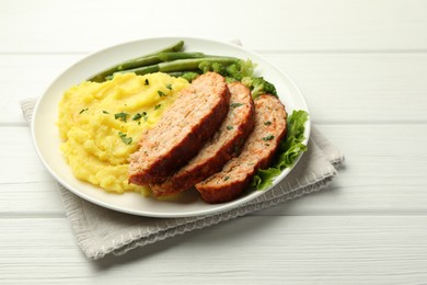 Photo of Delicious baked turkey meatloaf with mashed potato served on white wooden table, closeup. Space for text