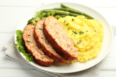 Photo of Delicious baked turkey meatloaf with mashed potato served on white wooden table, closeup