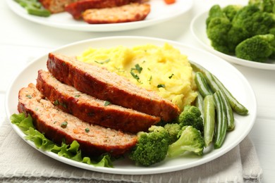 Photo of Delicious baked turkey meatloaf with mashed potato served on table, closeup