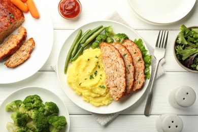 Photo of Delicious baked turkey meatloaf with mashed potato served on white wooden table, flat lay