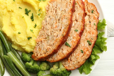 Photo of Delicious baked turkey meatloaf with mashed potato served on table, top view