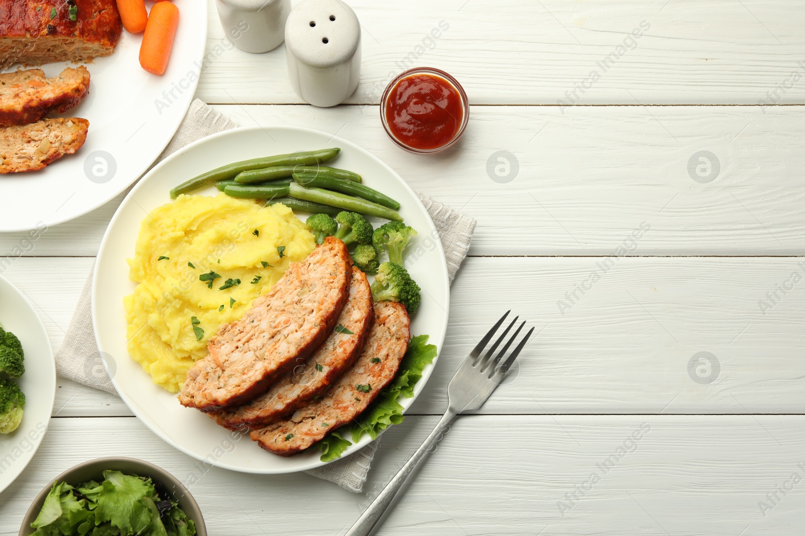 Photo of Delicious baked turkey meatloaf with mashed potato served on white wooden table, flat lay. Space for text