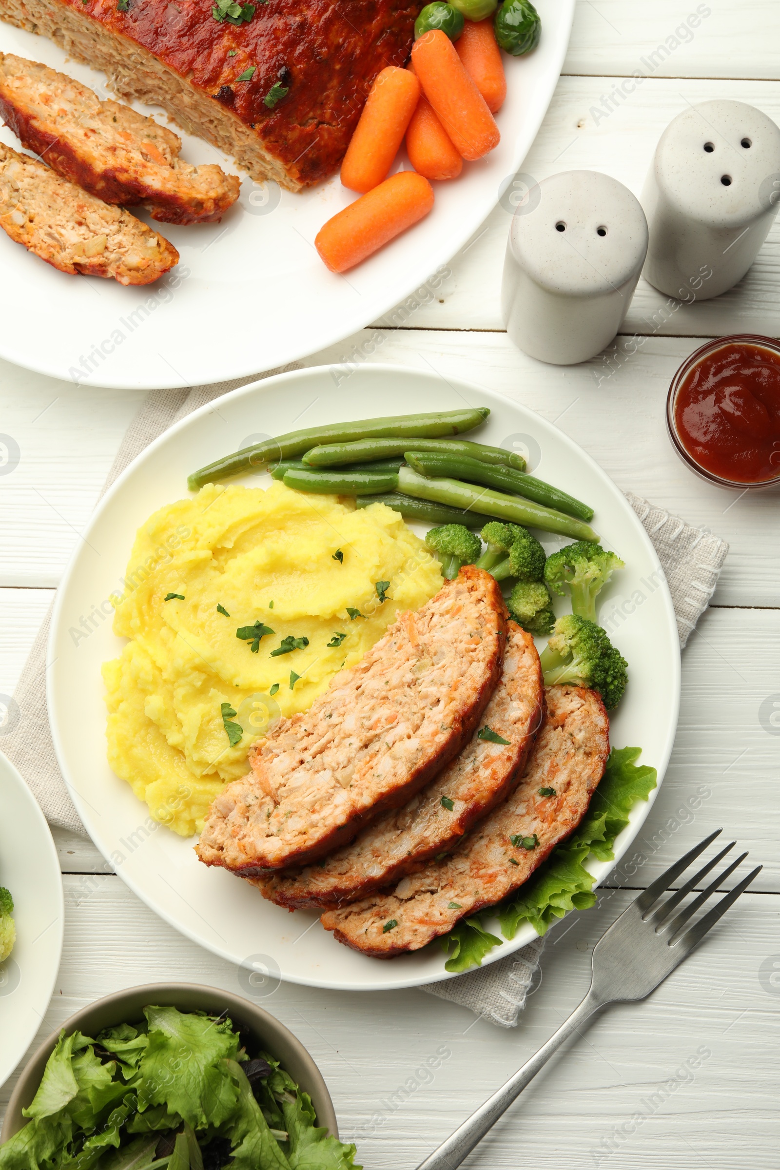 Photo of Delicious baked turkey meatloaf with mashed potato served on white wooden table, flat lay