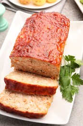 Photo of Delicious baked turkey meatloaf with parsley on table, closeup