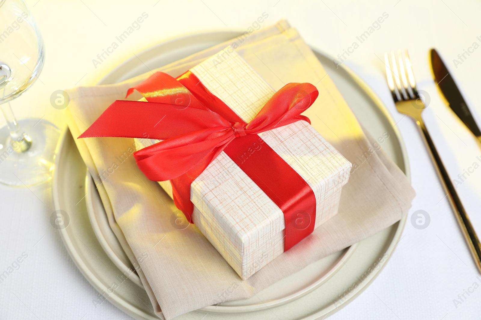 Photo of Gift and setting for romantic dinner on white background, closeup