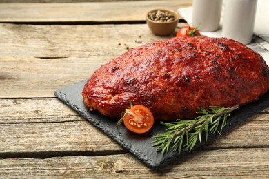 Photo of Delicious turkey meatloaf with tomatoes and rosemary on wooden table. Space for text