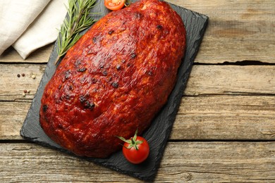 Photo of Delicious turkey meatloaf with tomatoes and rosemary on wooden table, top view