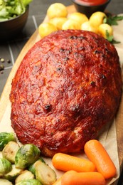 Photo of Delicious turkey meatloaf with vegetables on grey table, closeup