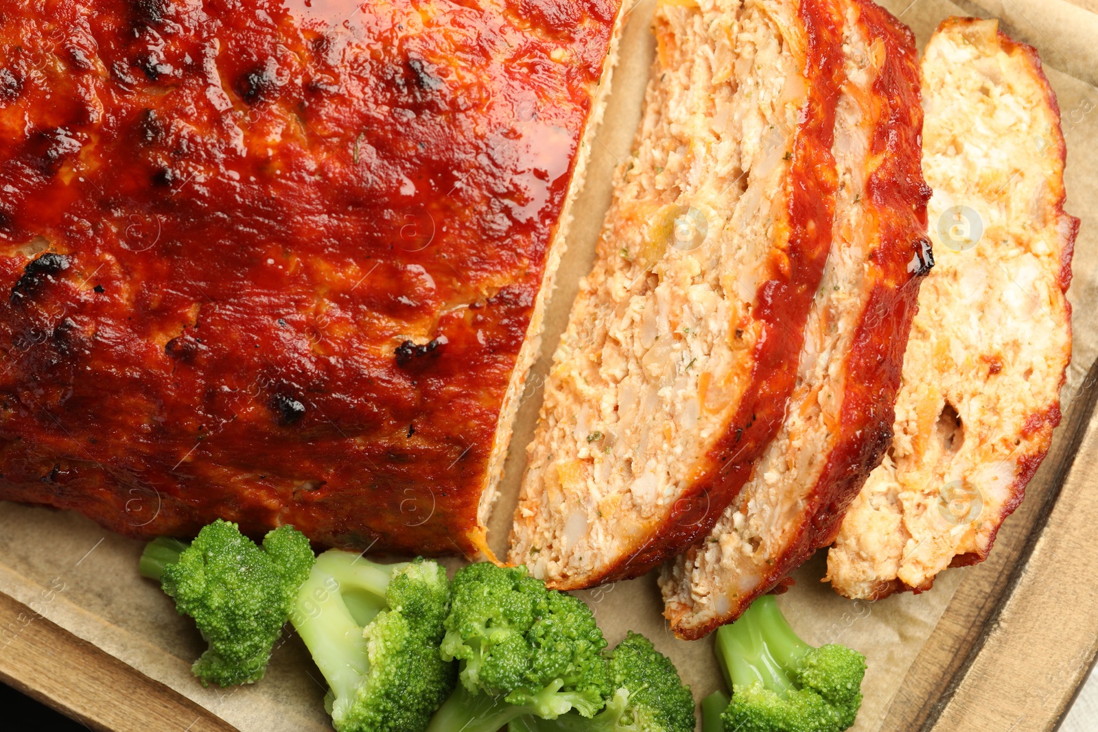 Photo of Delicious baked turkey meatloaf with vegetables on table, closeup