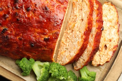 Photo of Delicious baked turkey meatloaf with vegetables on table, closeup