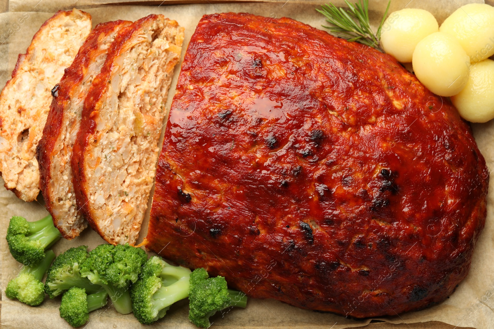 Photo of Delicious baked turkey meatloaf with vegetables on table, closeup