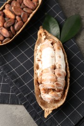 Cocoa pods with beans on grey table, closeup