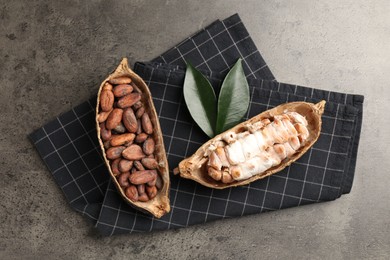 Photo of Cocoa pods with beans on grey table, top view