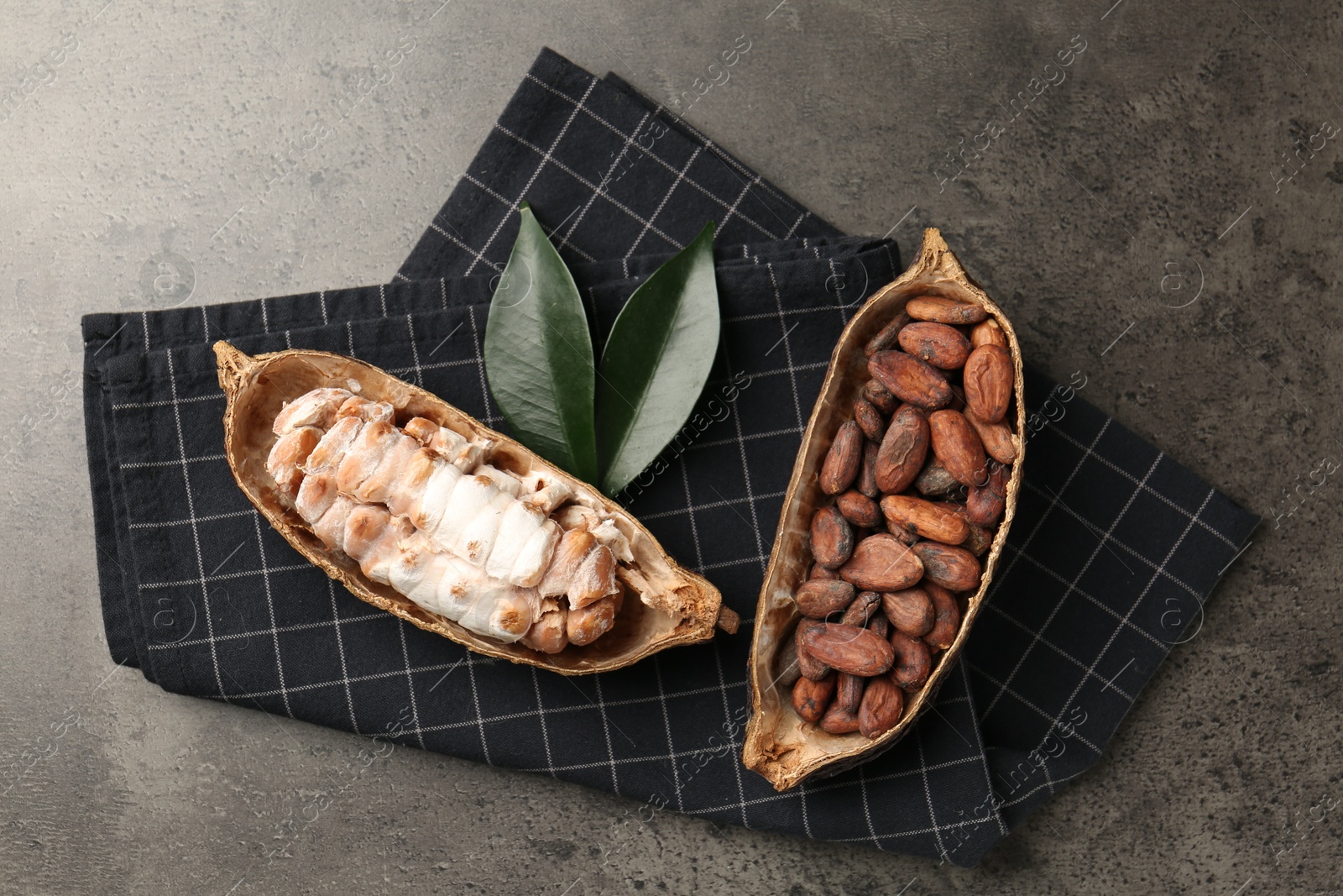 Photo of Cocoa pods with beans on grey table, top view