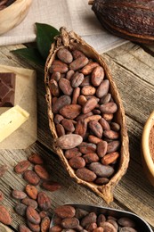 Cocoa pod with beans and butter on wooden table