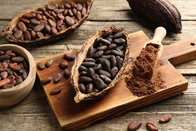 Cocoa pods with beans and powder on wooden table