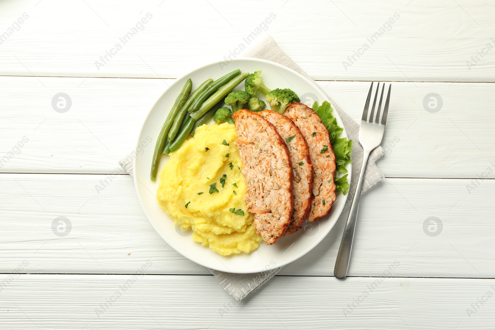 Photo of Delicious baked turkey meatloaf with mashed potato served on white wooden table, top view