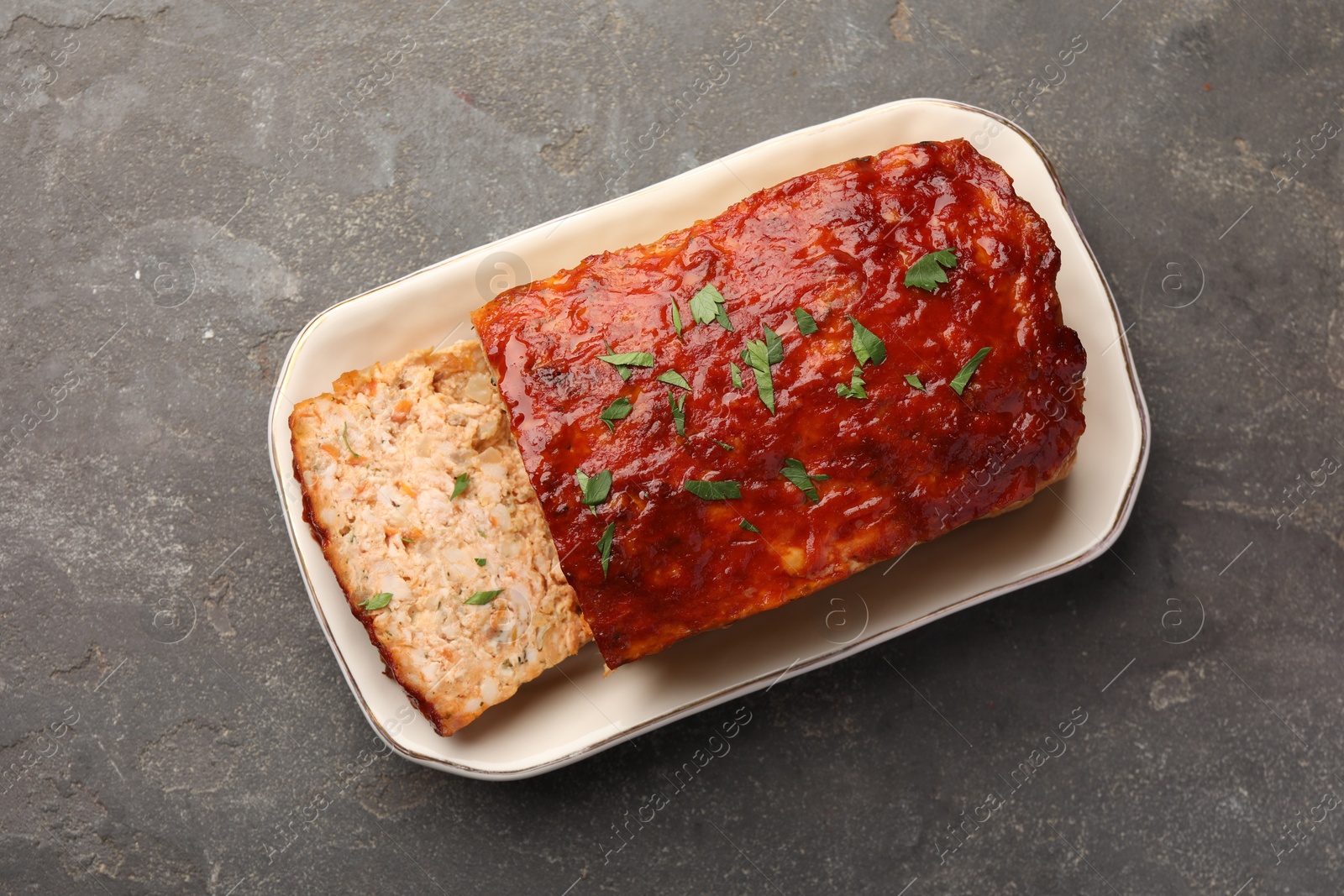 Photo of Delicious baked turkey meatloaf on grey table, top view