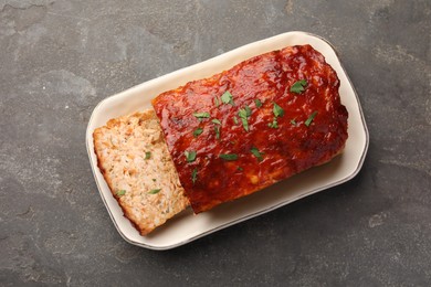 Photo of Delicious baked turkey meatloaf on grey table, top view