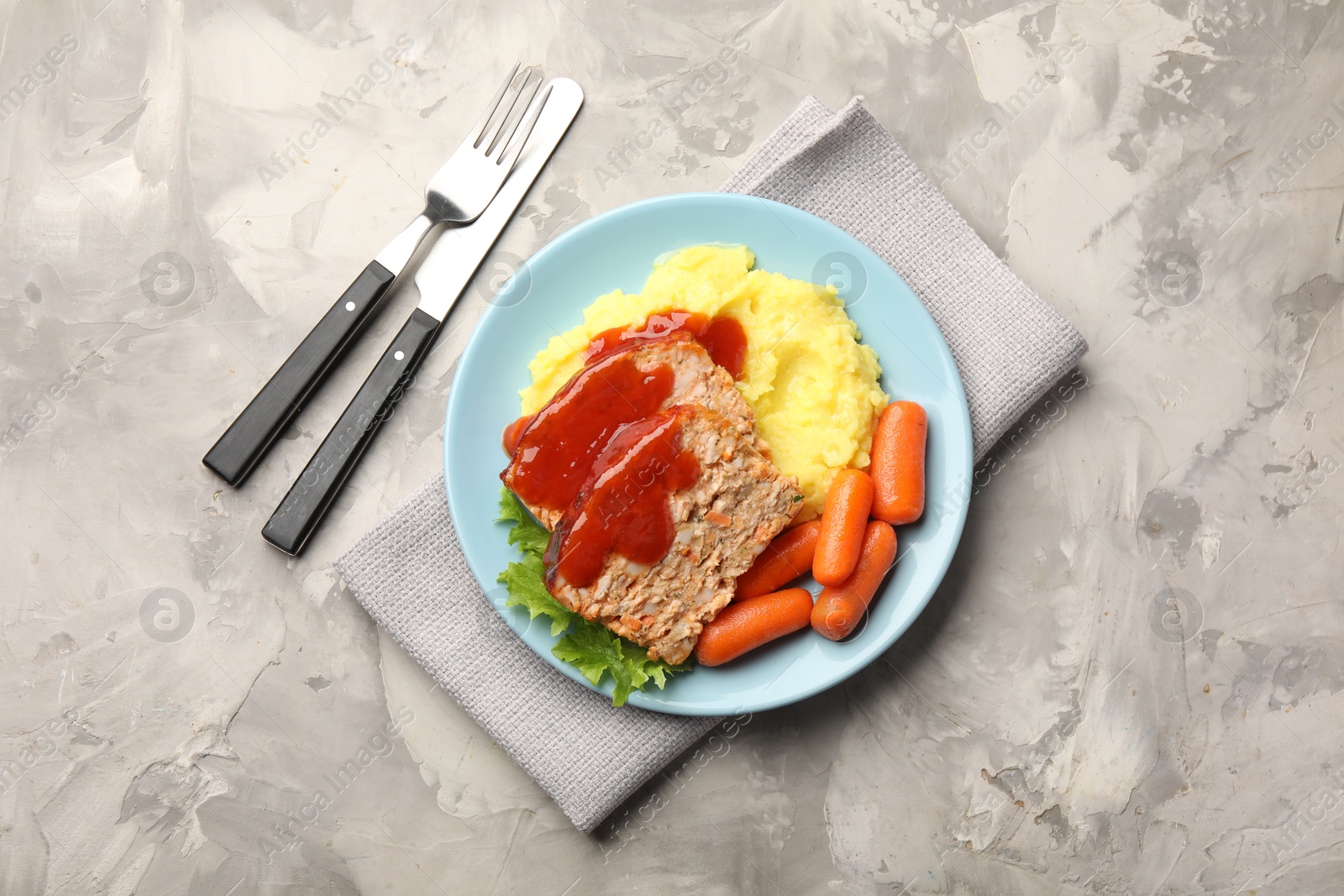 Photo of Delicious baked turkey meatloaf with mashed potato served on grey table, flat lay