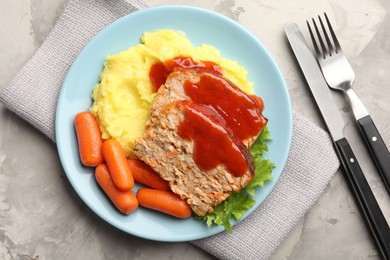 Photo of Delicious baked turkey meatloaf with mashed potato served on grey table, flat lay