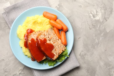 Photo of Delicious baked turkey meatloaf with mashed potato served on grey table, top view. Space for text