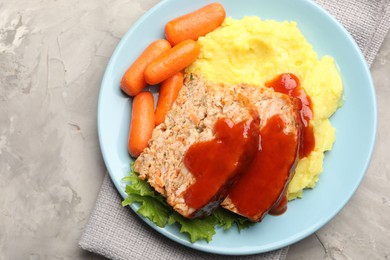 Photo of Delicious baked turkey meatloaf with mashed potato served on grey table, top view