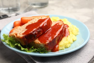 Photo of Delicious baked turkey meatloaf with mashed potato served on table, closeup