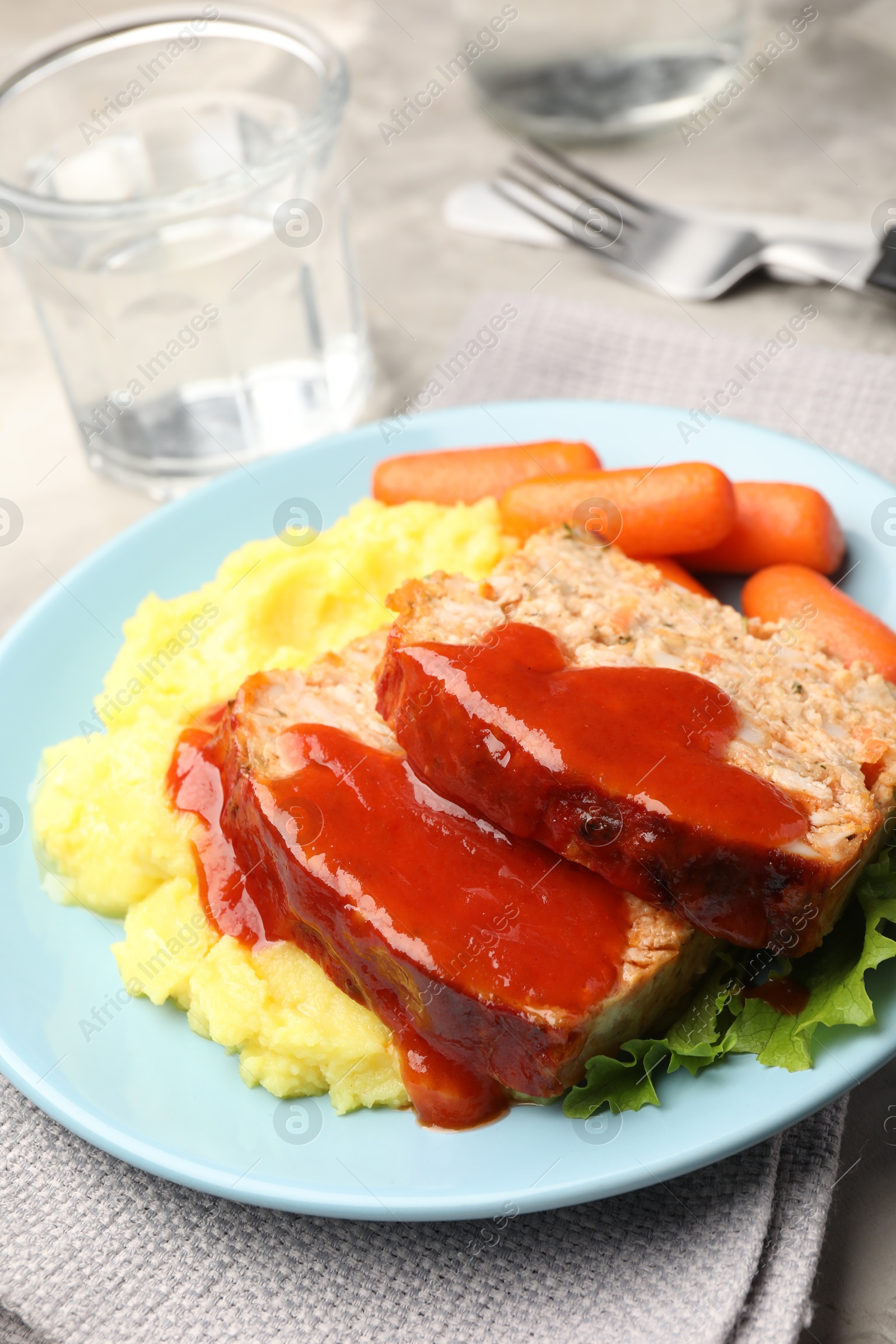 Photo of Delicious baked turkey meatloaf with mashed potato served on table, closeup