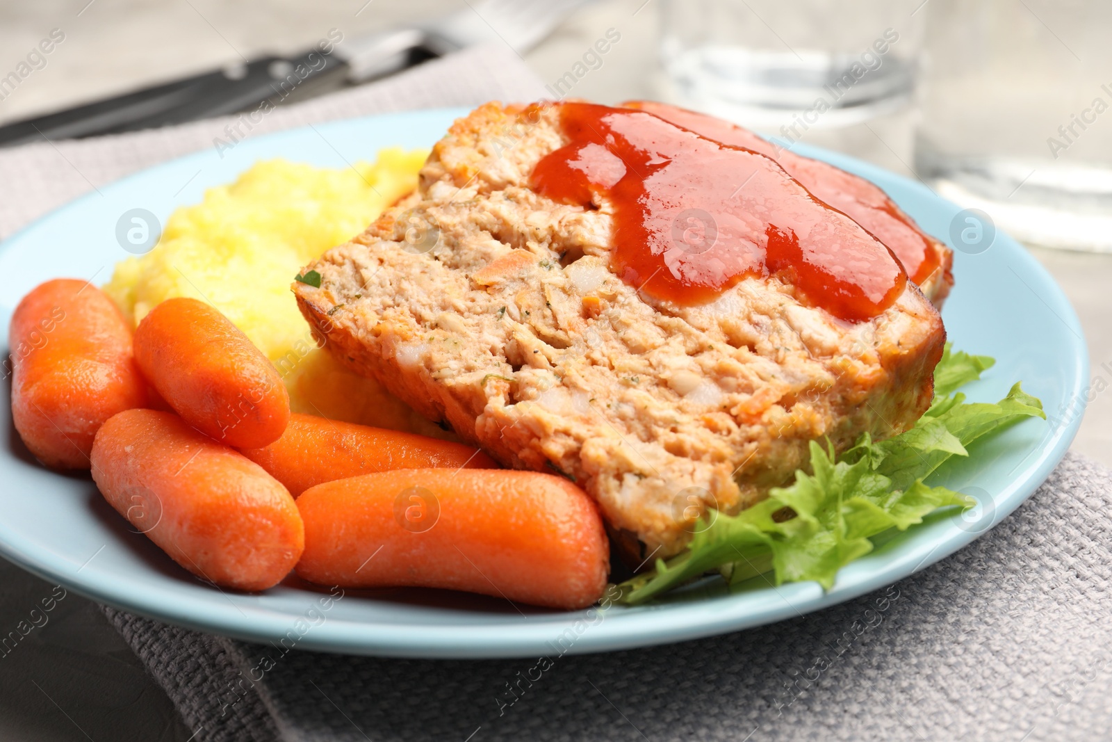 Photo of Delicious baked turkey meatloaf with mashed potato served on table, closeup