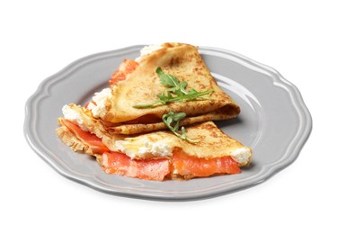 Delicious crepes with salmon, cream cheese and arugula isolated on white