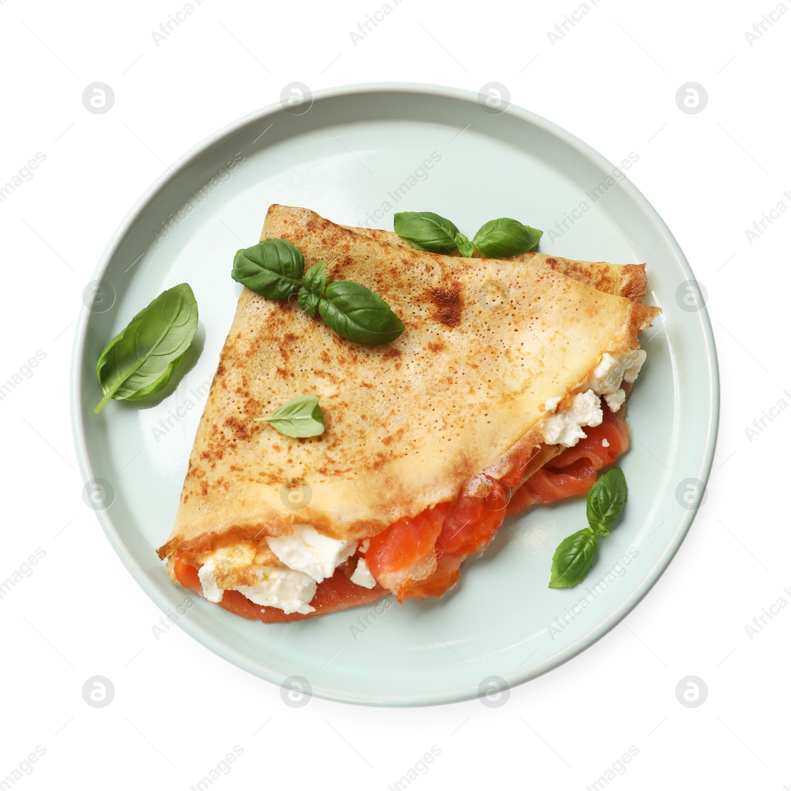 Photo of Delicious crepe with salmon, cream cheese and basil isolated on white, top view