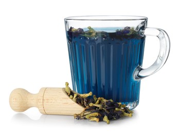 Photo of Fresh butterfly pea flower tea in cup and scoop with dry petals isolated on white