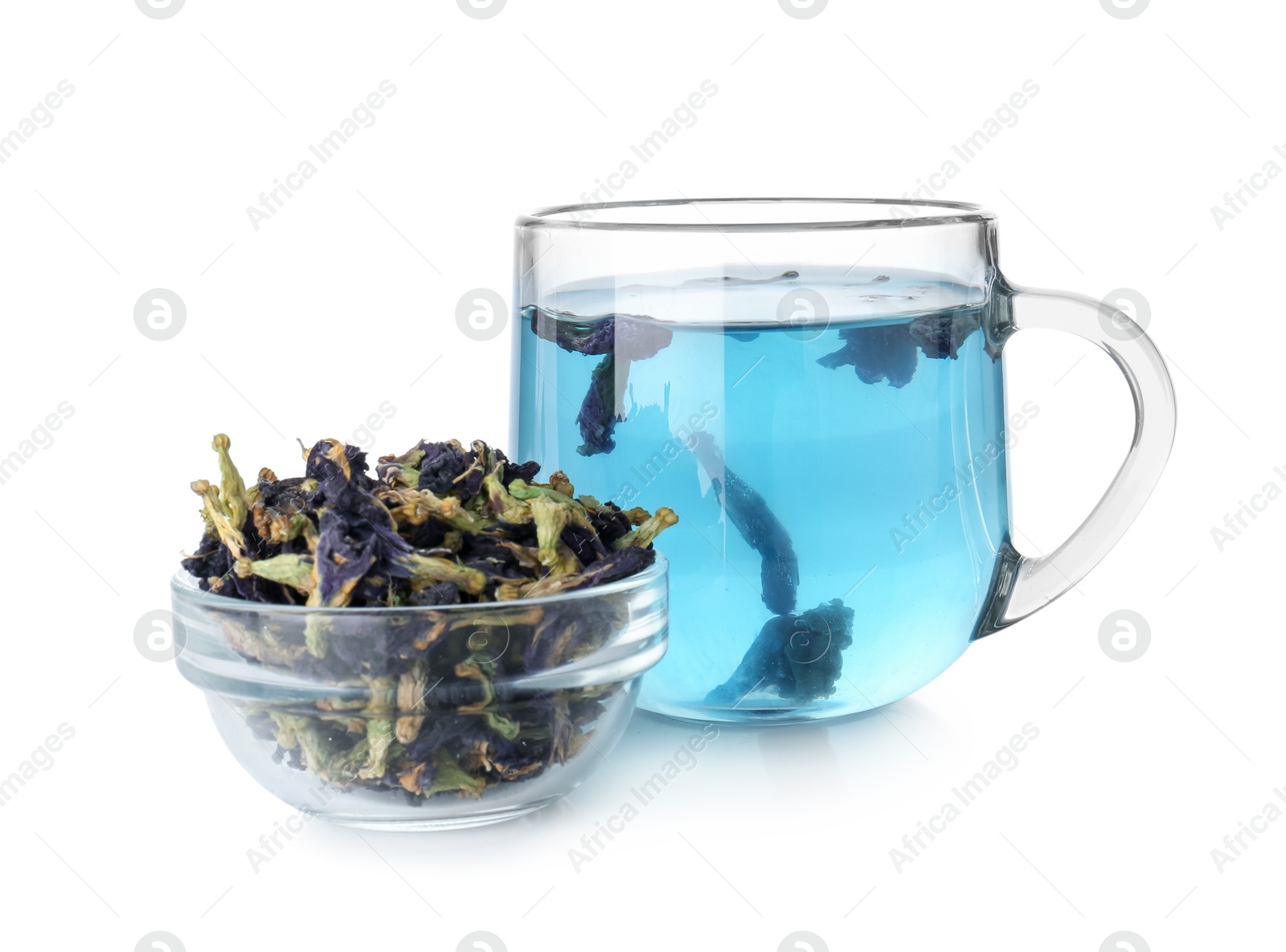 Photo of Delicious butterfly pea flower tea in glass cup and dry petals isolated on white