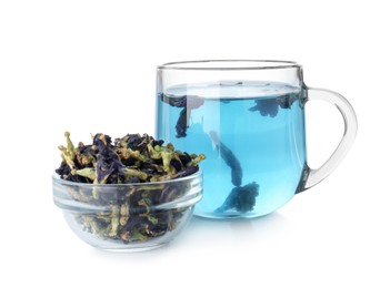 Photo of Delicious butterfly pea flower tea in glass cup and dry petals isolated on white