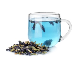 Photo of Delicious butterfly pea flower tea in glass cup and dry petals isolated on white