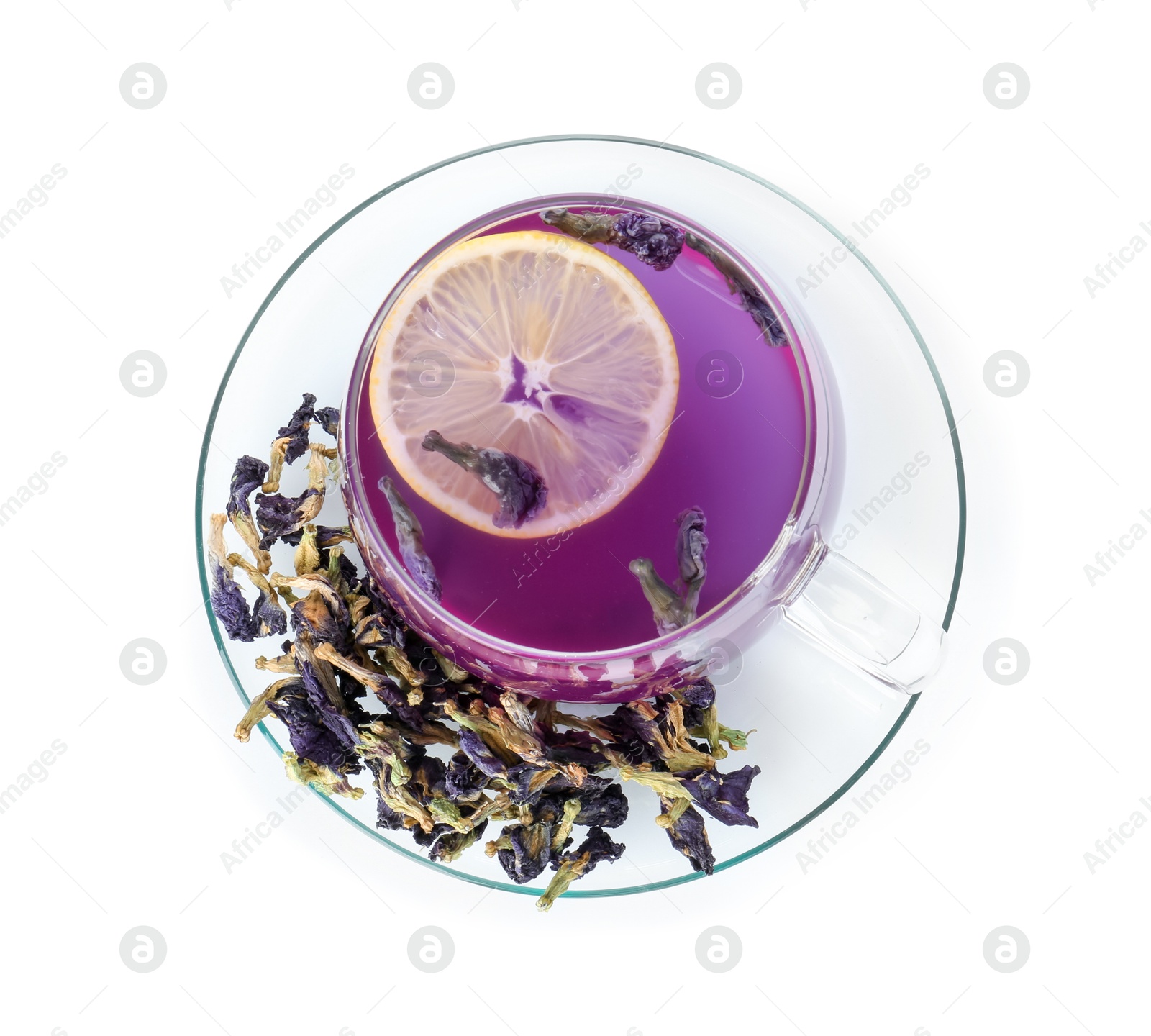 Photo of Delicious butterfly pea flower tea with lemon in glass cup and dry petals isolated on white, top view