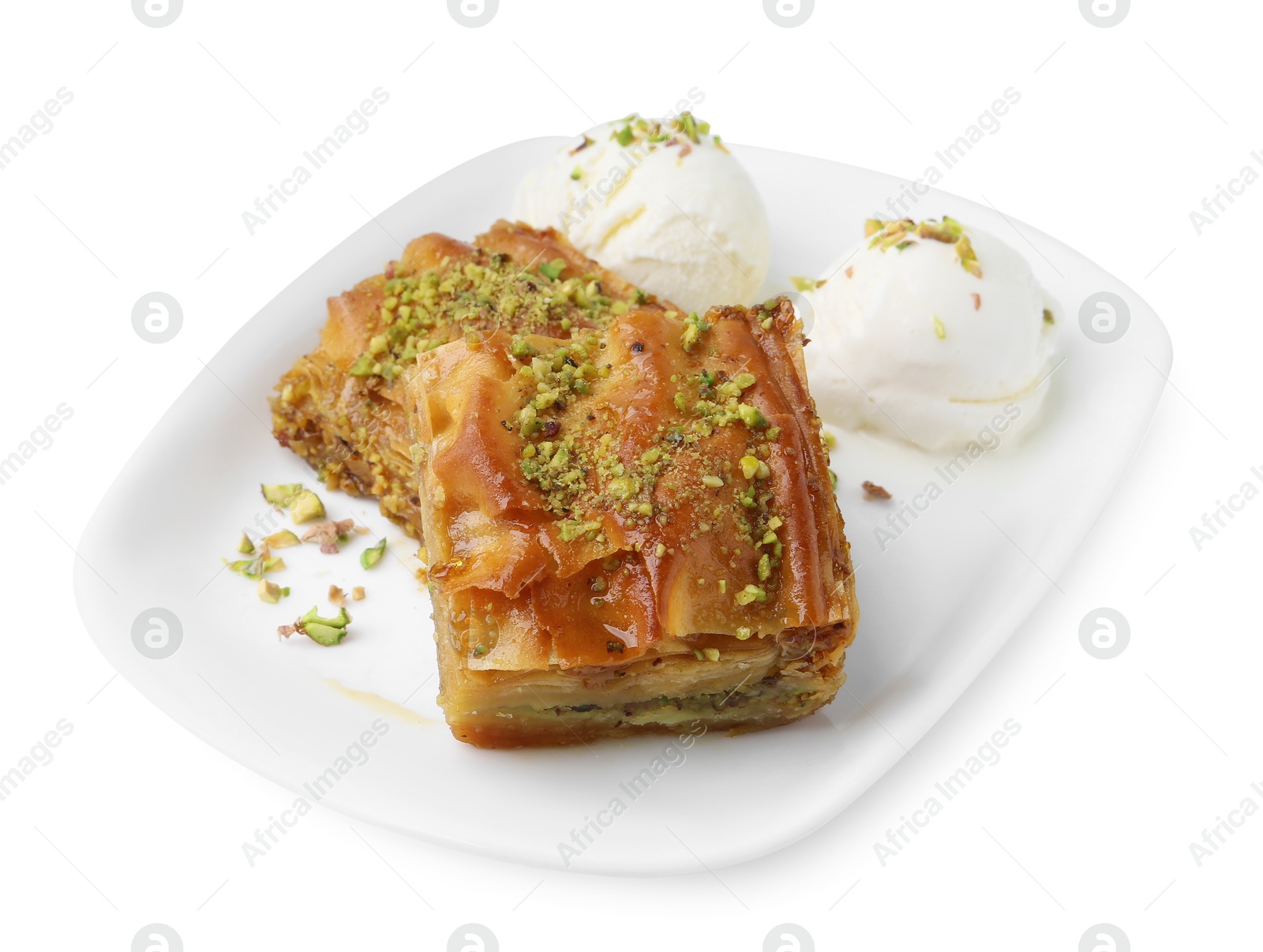 Photo of Delicious baklava with crushed nuts and ice cream isolated on white