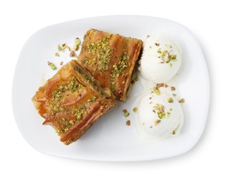 Photo of Delicious baklava with crushed nuts and ice cream isolated on white, top view