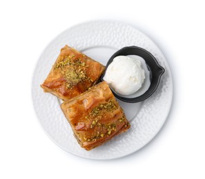 Photo of Delicious baklava with crushed nuts and ice cream isolated on white, top view