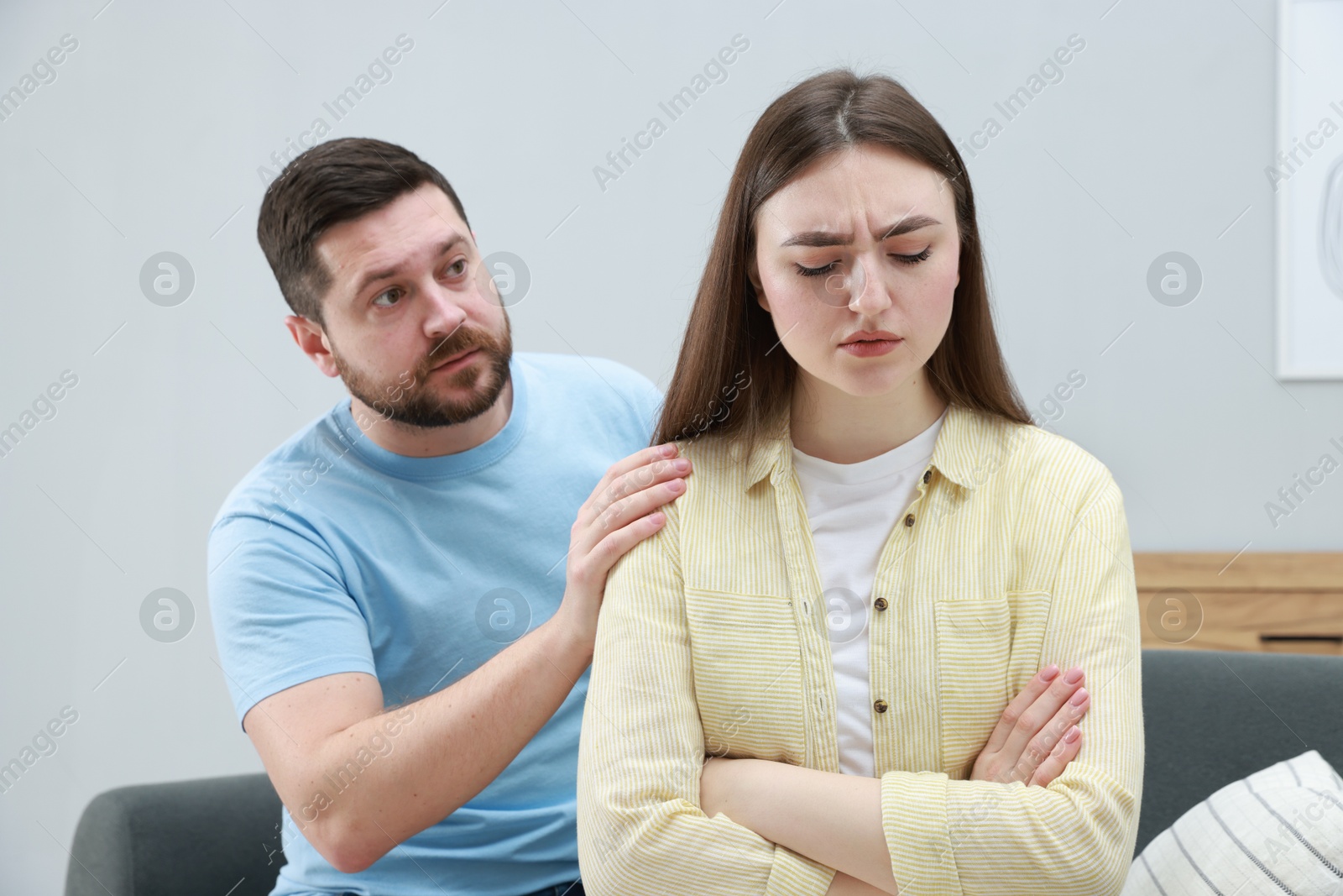 Photo of Man comforting his resentful girlfriend at home