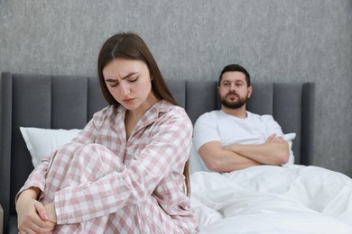 Photo of Resentful couple on bed at home, selective focus