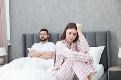 Photo of Resentful couple on bed at home, selective focus