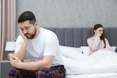 Photo of Resentful couple on bed at home, selective focus